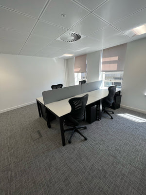 Second hand bench desks and spine mesh back chairs in an office in Richmond, London.