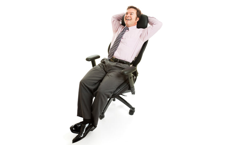 Man sitting on a used office chair with back tilt