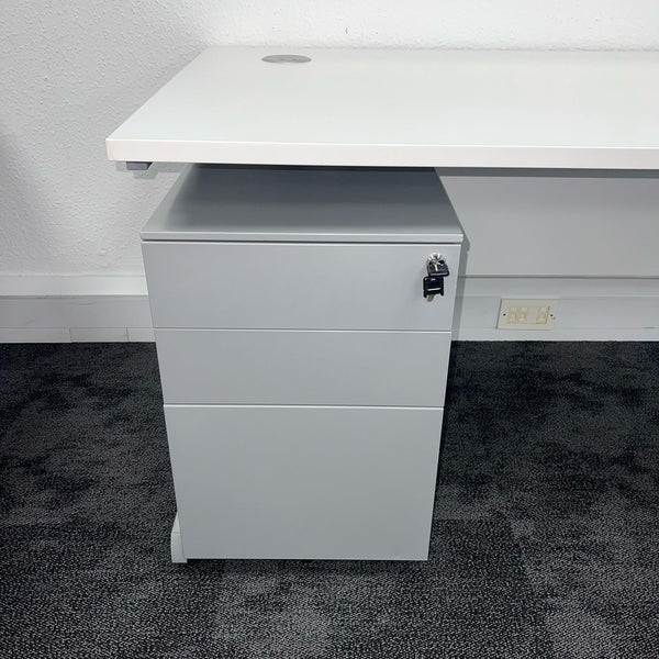 closeup of metal mobile pedestal under a white cantilever office desk