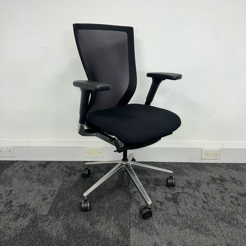front-right view of a second hand office operator chair on white wall background, London office