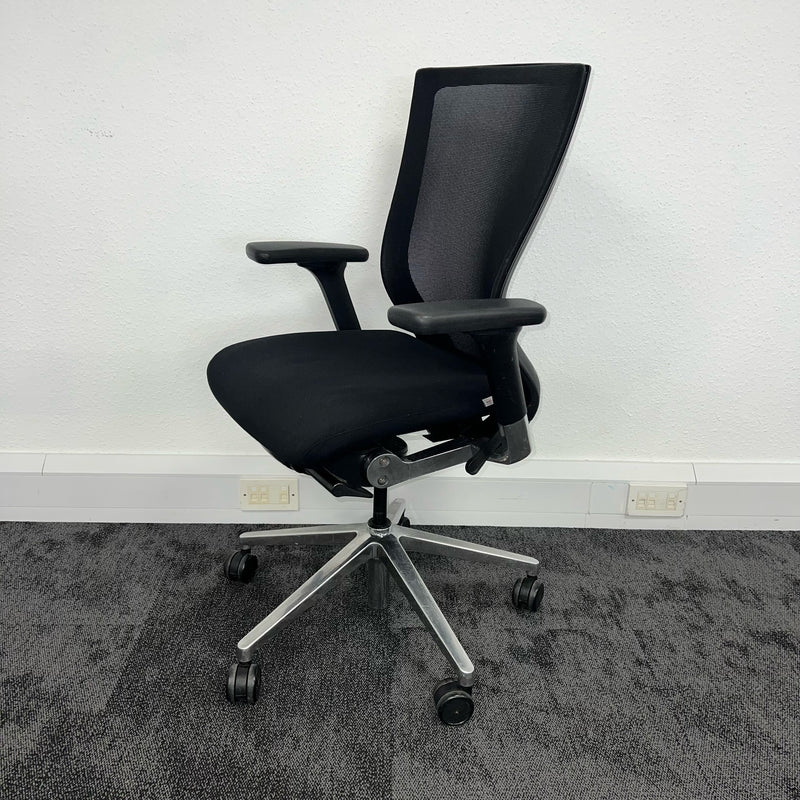 left side view of a black mesh backrest operator chair, used office furniture