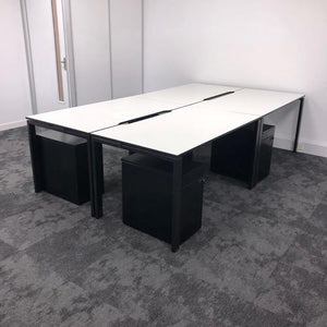 black and white used office bench desks and black pedestals with drawers