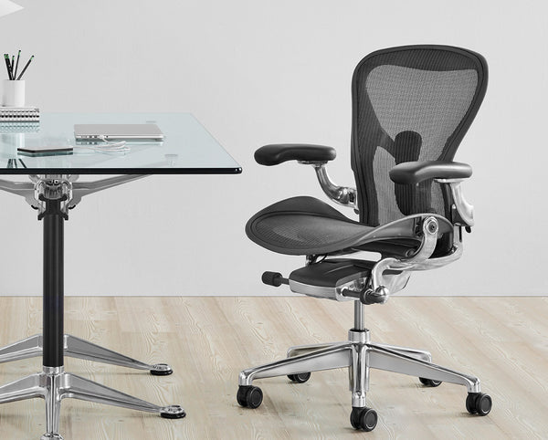 Go to article: Herman Miller Aeron office chair near a glass office desk on light wooden floor