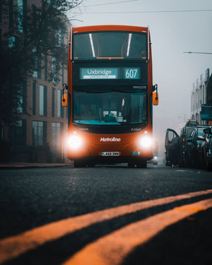 A red double decker bus on a foggy day in a street of Uxbridge in Hilingdon in London