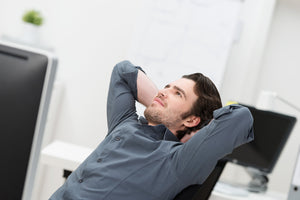 man sitting and relaxing in an office chair 