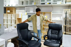 man choosing used office chairs in a second hand office furniture shop