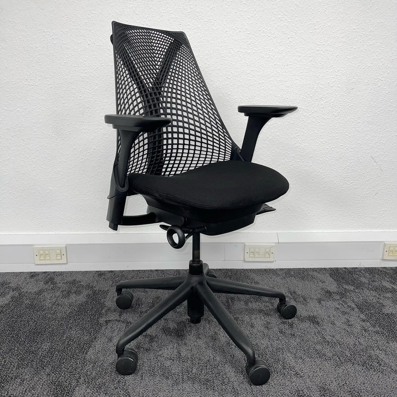 used herman miller chair on background of office wall