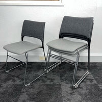 stack of meeting office chairs with grey finish
