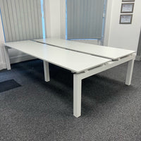 used bench desks grouped in a pod of four in London office